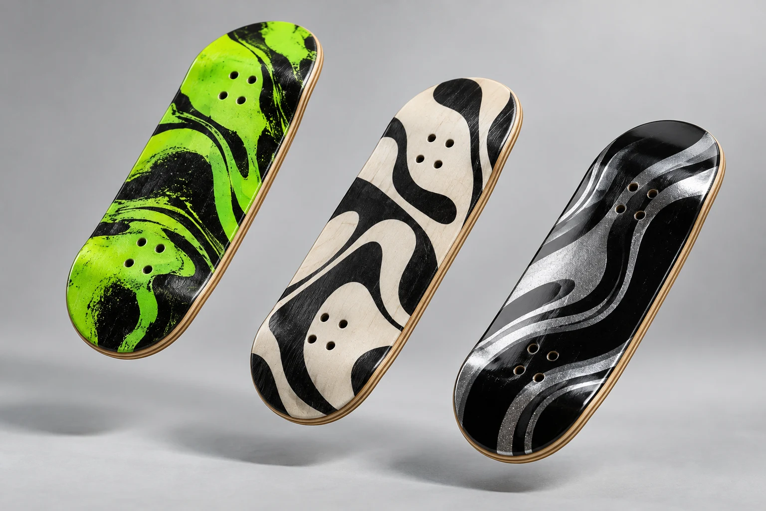 Three fingerboard deck concepts with green, black and ivory abstract graphics